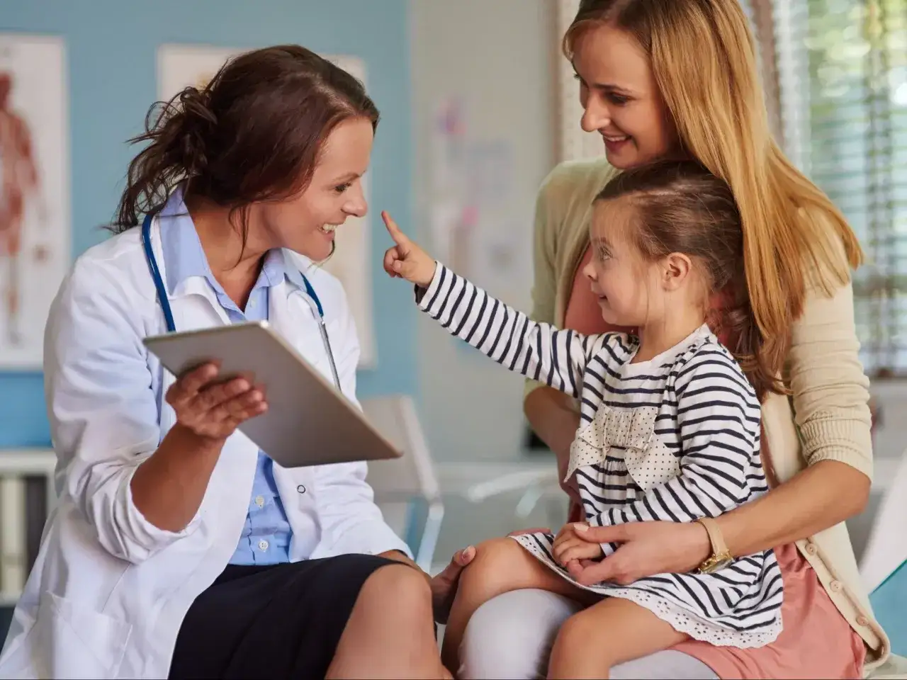 Lekarz konsultujący się z rodzicami dziecka w gabinecie medycznym