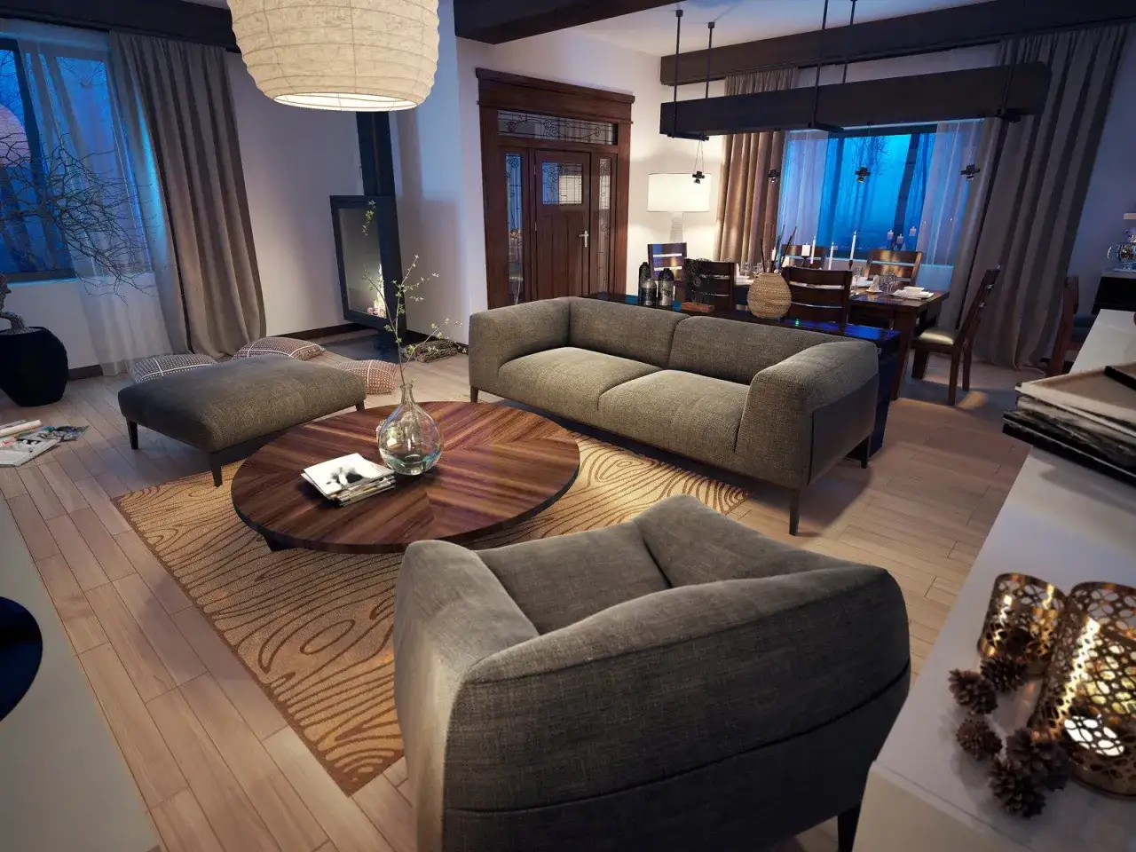 Przytulny salon w stylu rustykalnym nowoczesnym: szara sofa, okrągły stolik z drewna, kominek i jadalnia w tle.