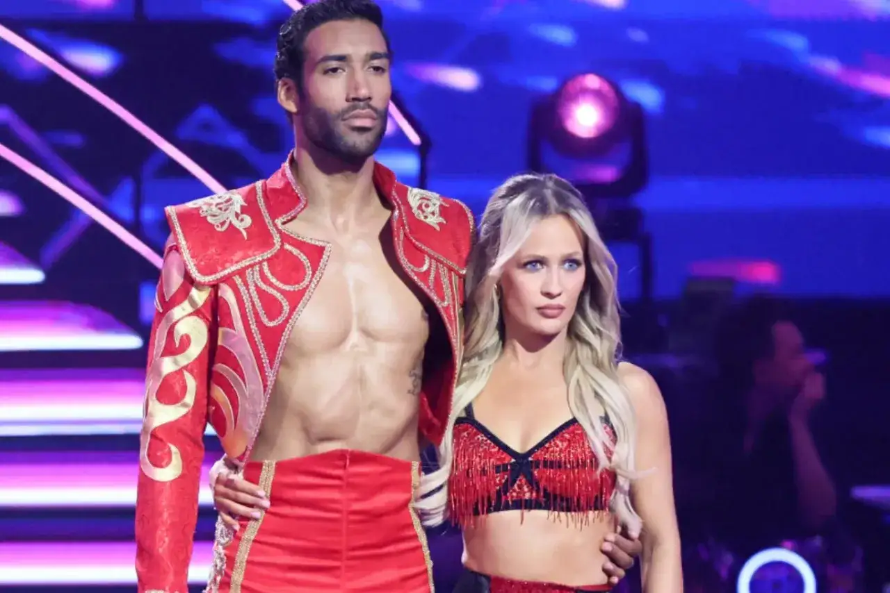 Para tańczy paso doble w czerwonych strojach. Mężczyzna w ozdobnej kurtce, kobieta w topie z frędzlami.