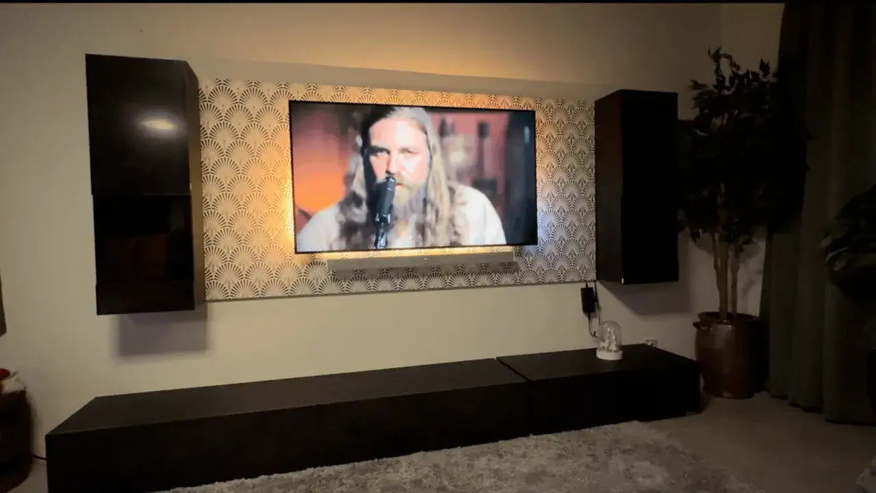 Osoba siedząca na kanapie z telewizorem na wysokości wzroku