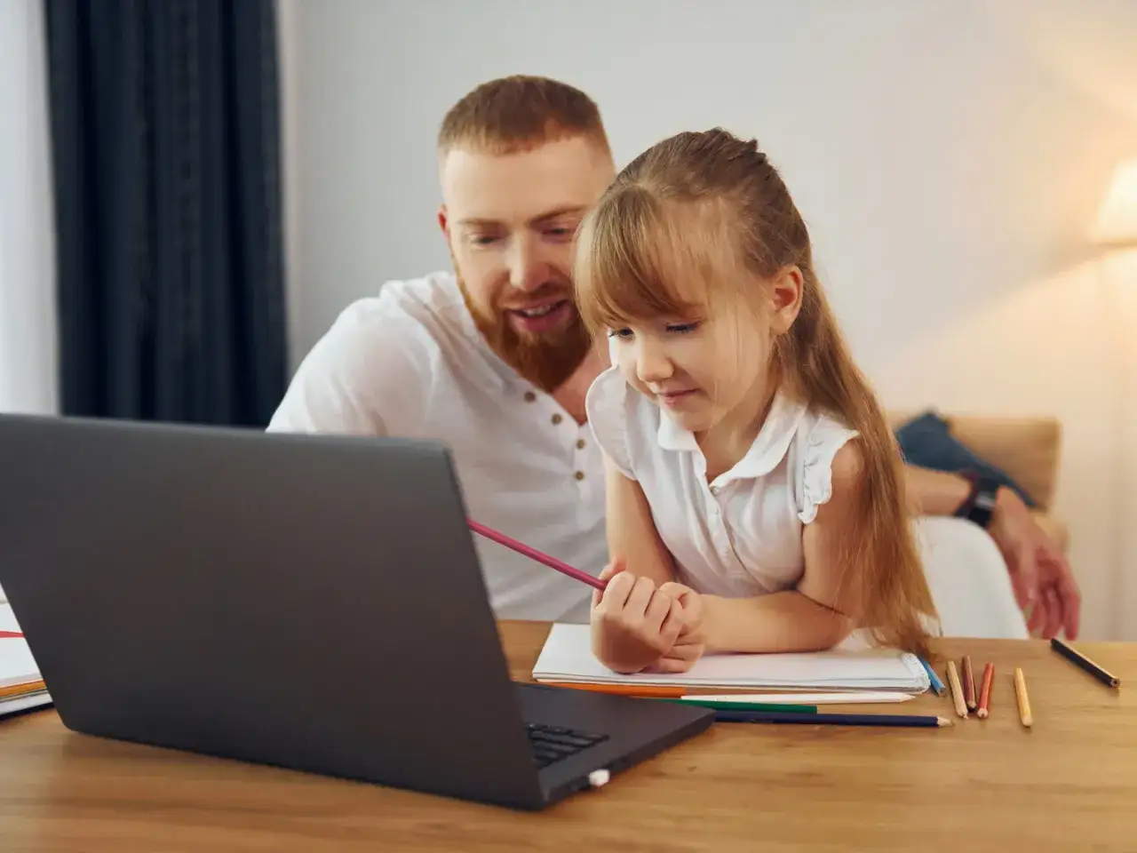 dziecko uczy się w domu, elastyczna edukacja, laptop i książki
