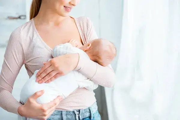kobieta karmiąca piersią uśmiechnięta