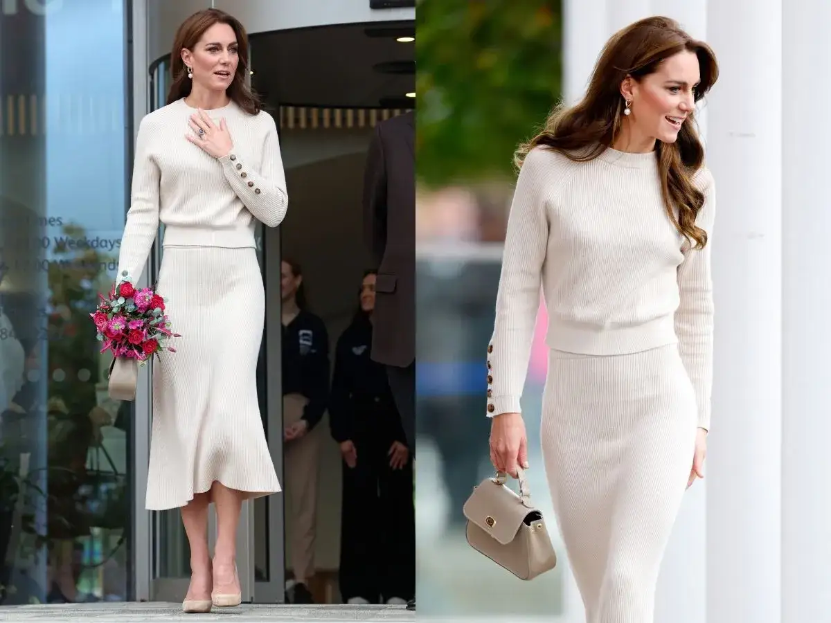 Księżna Kate w kremowej, dzianinowej sukience z rozkloszowaną sp&oacute;dnicą i ozdobnymi guzikami na rękawach. Elegancka stylizacja z bukietem kwiat&oacute;w.