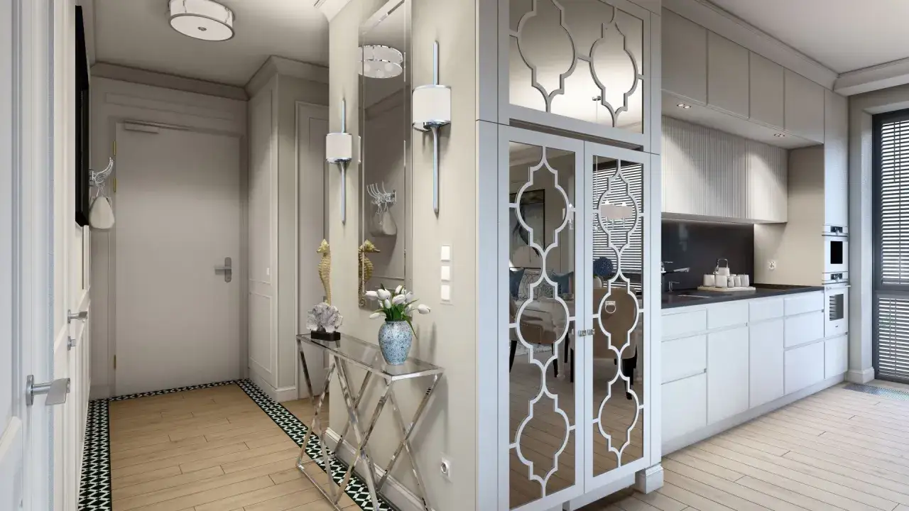 Elegancka ściana z luster w przedpokoju, odbijająca światło i dodająca przestrzeni. Obok kuchnia i drzwi.