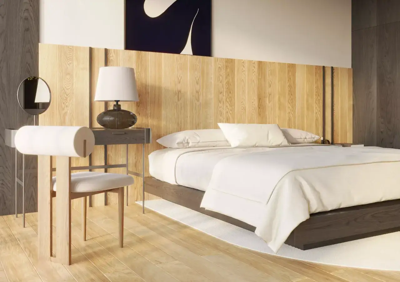 Nowoczesna sypialnia z drewnianym zagł&oacute;wkiem. Lampa nocna stoi na stoliku, a obok znajduje się toaletka z lustrem. Idealna wysokość kinkietu przy ł&oacute;żku zapewnia komfort.