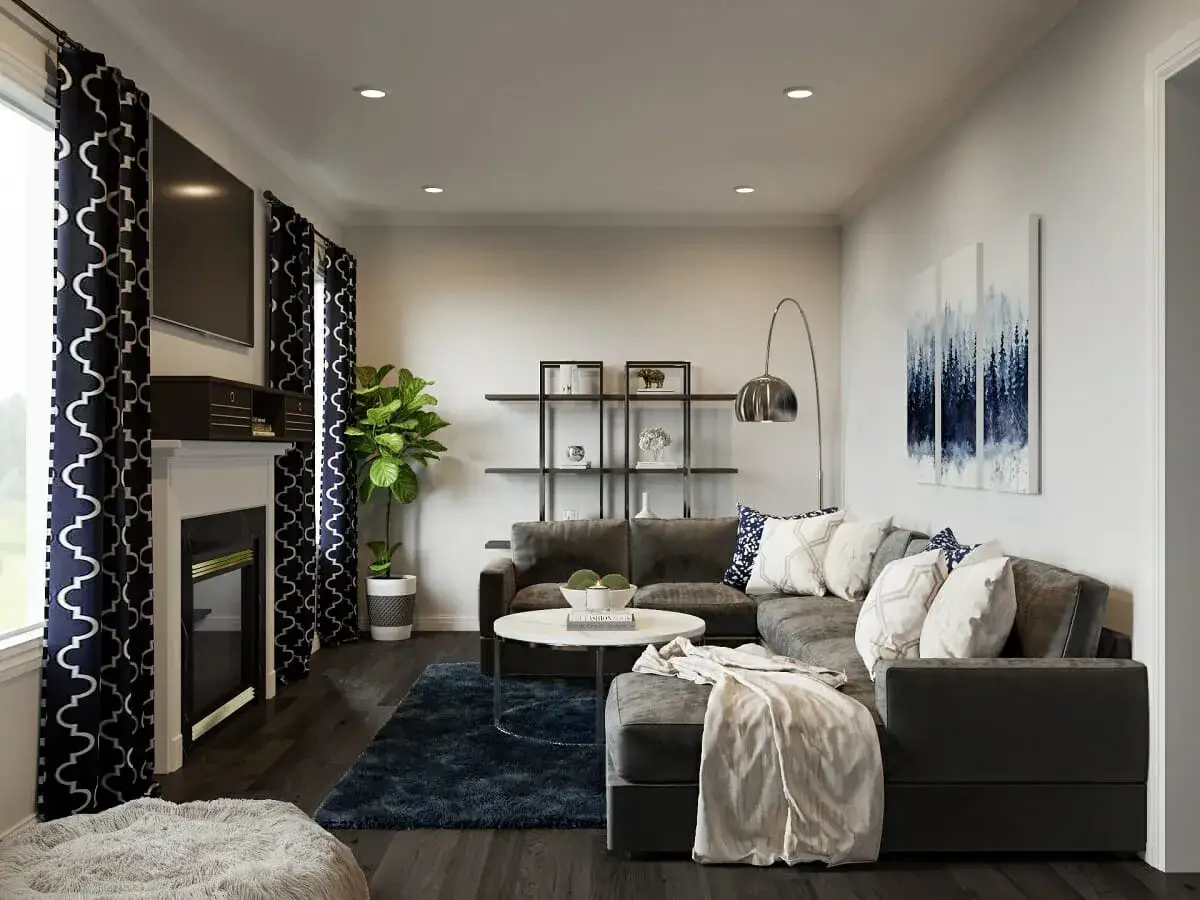 Jak rozjaśnić salon z ciemnymi meblami? Jasne dodatki, dywan i grafiki na ścianach dodają lekkości.