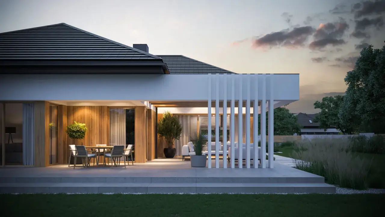 Nowoczesny, mały taras przy domu z jadalnią i strefą wypoczynkową. Drewniana ściana, biała pergola i oświetlenie tworzą przytulną atmosferę.