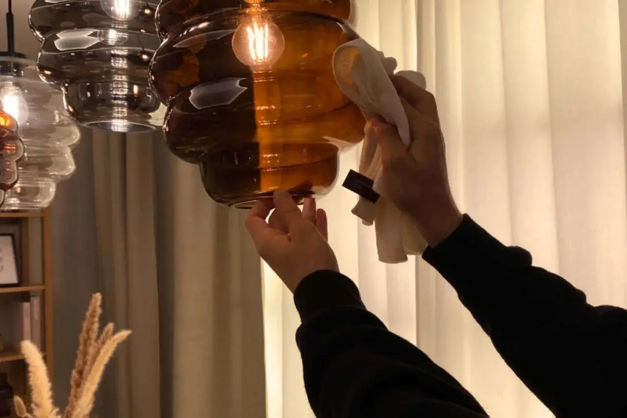 Delikatnie wyczyść bursztynowy abażur z lampy, używając miękkiej ściereczki. To prosty sposób, jak wyczyścić abażur z lampy, by znów lśnił.