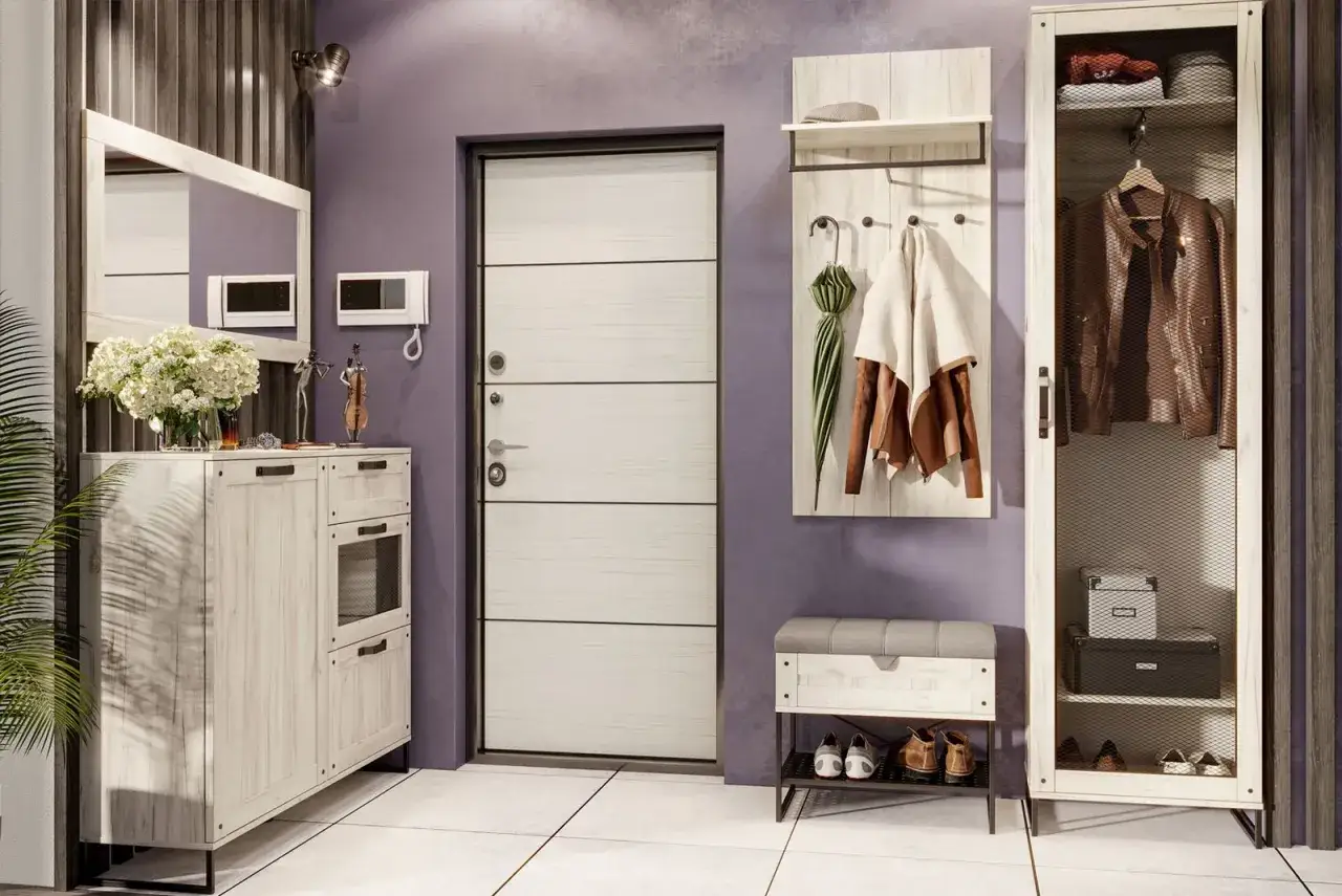 Stylowa zabudowa wnęki w przedpokoju: biała komoda, lustro, wieszak z kurtkami i parasolem, szafka na buty i wysoka szafa.