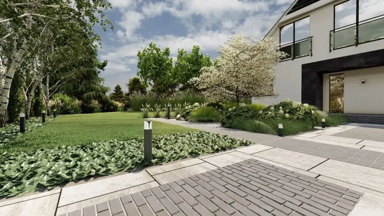 Długi wjazd na posesję z nowoczesnym domem, bujną zielenią i kwitnącym drzewem.