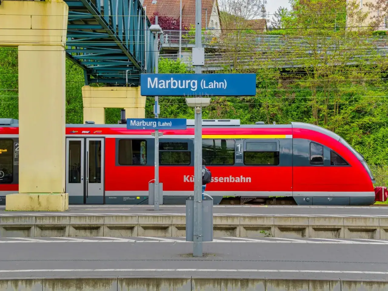 Czerwony pociąg na stacji Marburg (Lahn). Podr&oacute;żowanie po Niemczech, ceny bilet&oacute;w są zr&oacute;żnicowane.