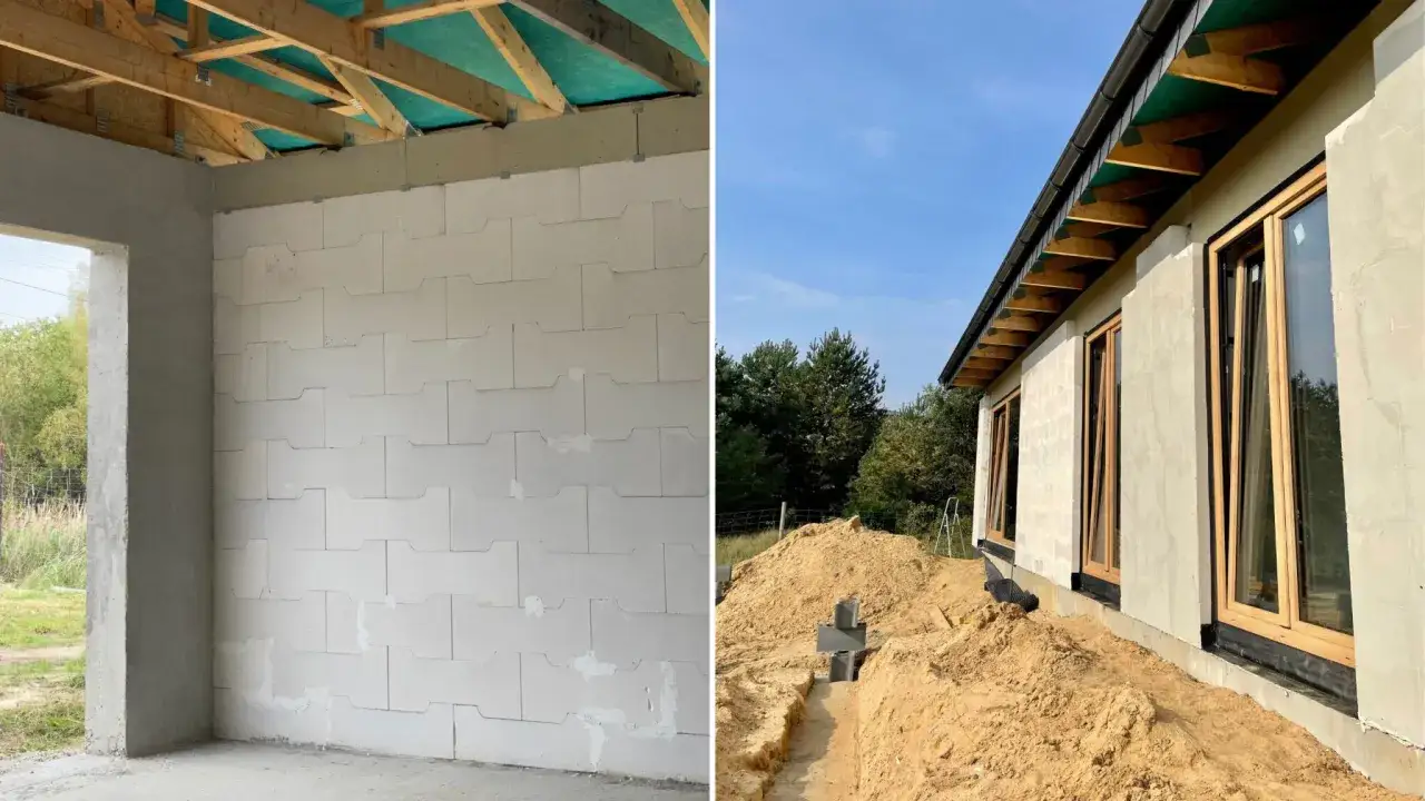 Budowa domu z perlitu w toku. Wnętrze z bloczk&oacute;w, z zewnątrz widać okna i dach.