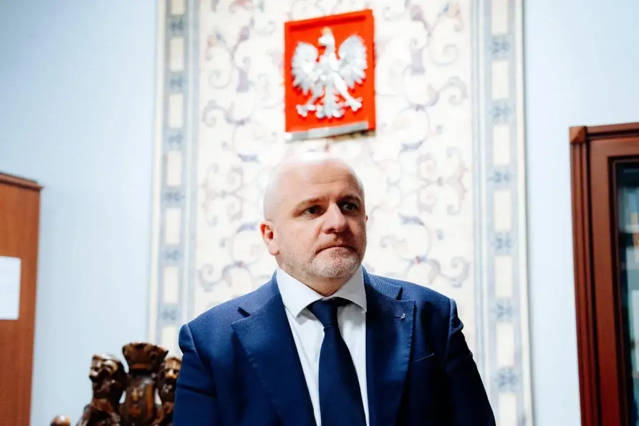 Paweł Kowal w garniturze, z orłem na ścianie, zastanawia się, dlaczego walczy o władzę w strukturach KO z Joanną Frydrych.