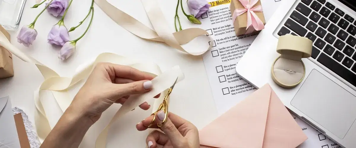 osoba robiąca zaproszenia ślubne DIY stół z narzędziami i materiałami