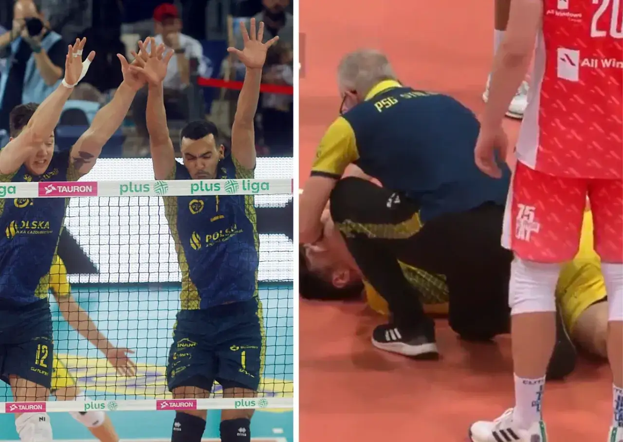 Siatkarze w granatowo-żółtych strojach, jeden z nich w getrach siatkarskich, blokuje piłkę. Obok trener pochyla się nad leżącym zawodnikiem.