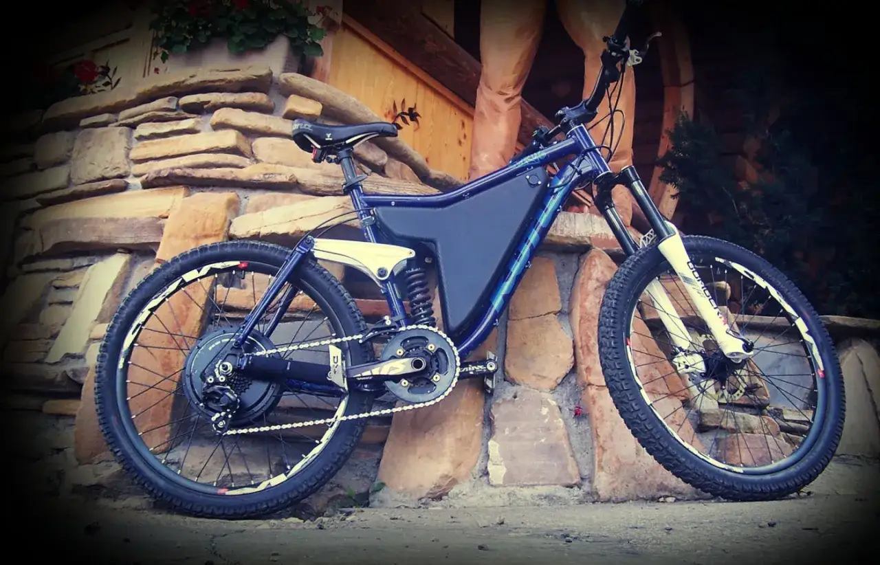 Niebieski rower górski z zamontowanym silnikiem i baterią w ramie. Zastanawiasz się, ile kosztuje przerobienie roweru na elektryczny?