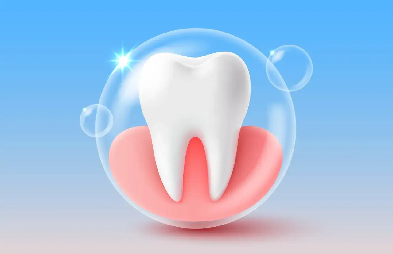 Biały ząb otoczony różowymi dziąsłami, wewnątrz bańki mydlanej. W czym jest fluor? W ochronie zębów!