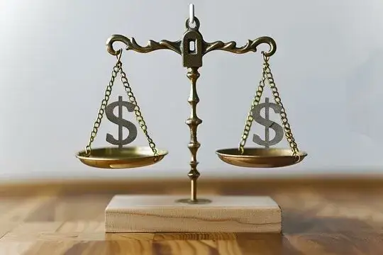 Symbol wagi szalkowej z monetami po obu stronach