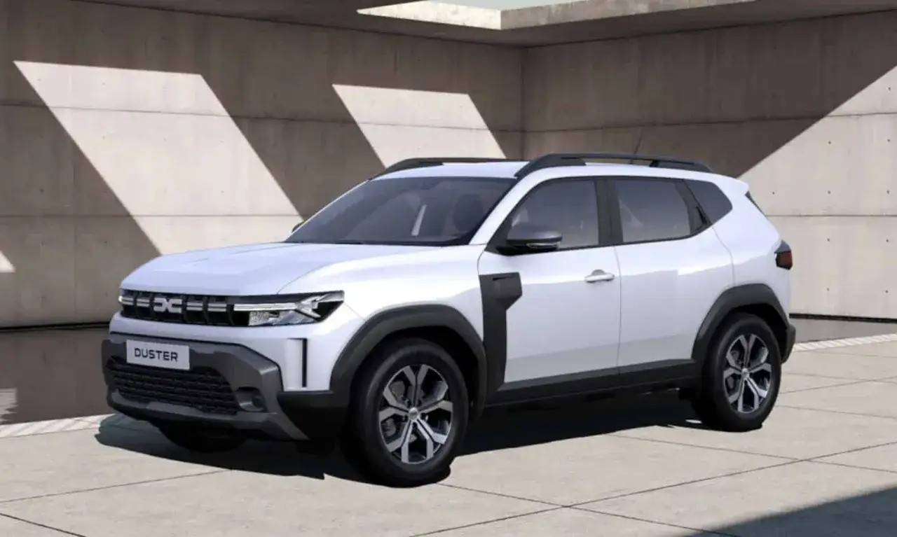 Nowy, biały Dacia Duster prezentuje się nowocześnie na tle betonowej ściany z geometrycznymi cieniami.