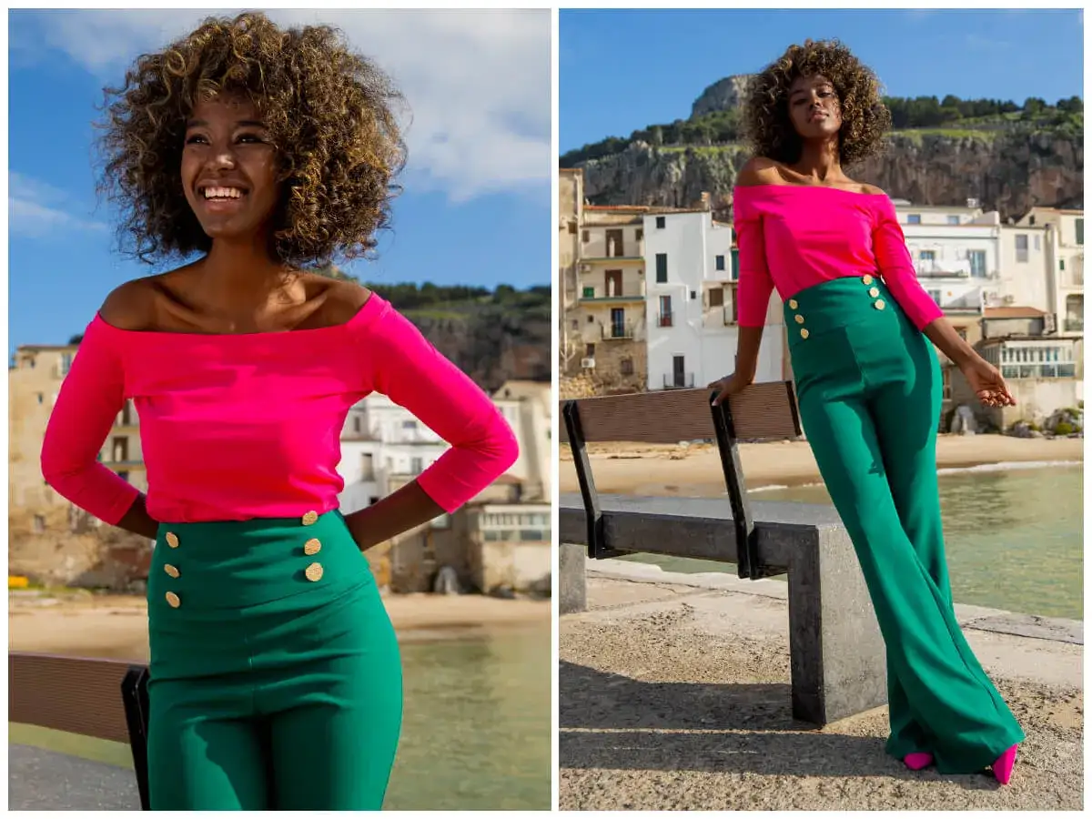 Modelka w fuksjowej bluzce hiszpance i zielonych spodniach z wysokim stanem, idealna na letnie dni.