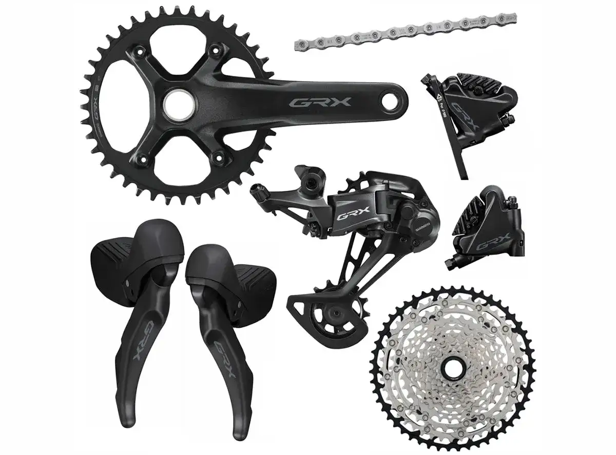 Zestaw komponent&oacute;w rowerowych Shimano GRX: korba, przerzutka, manetki, hamulce i kaseta.