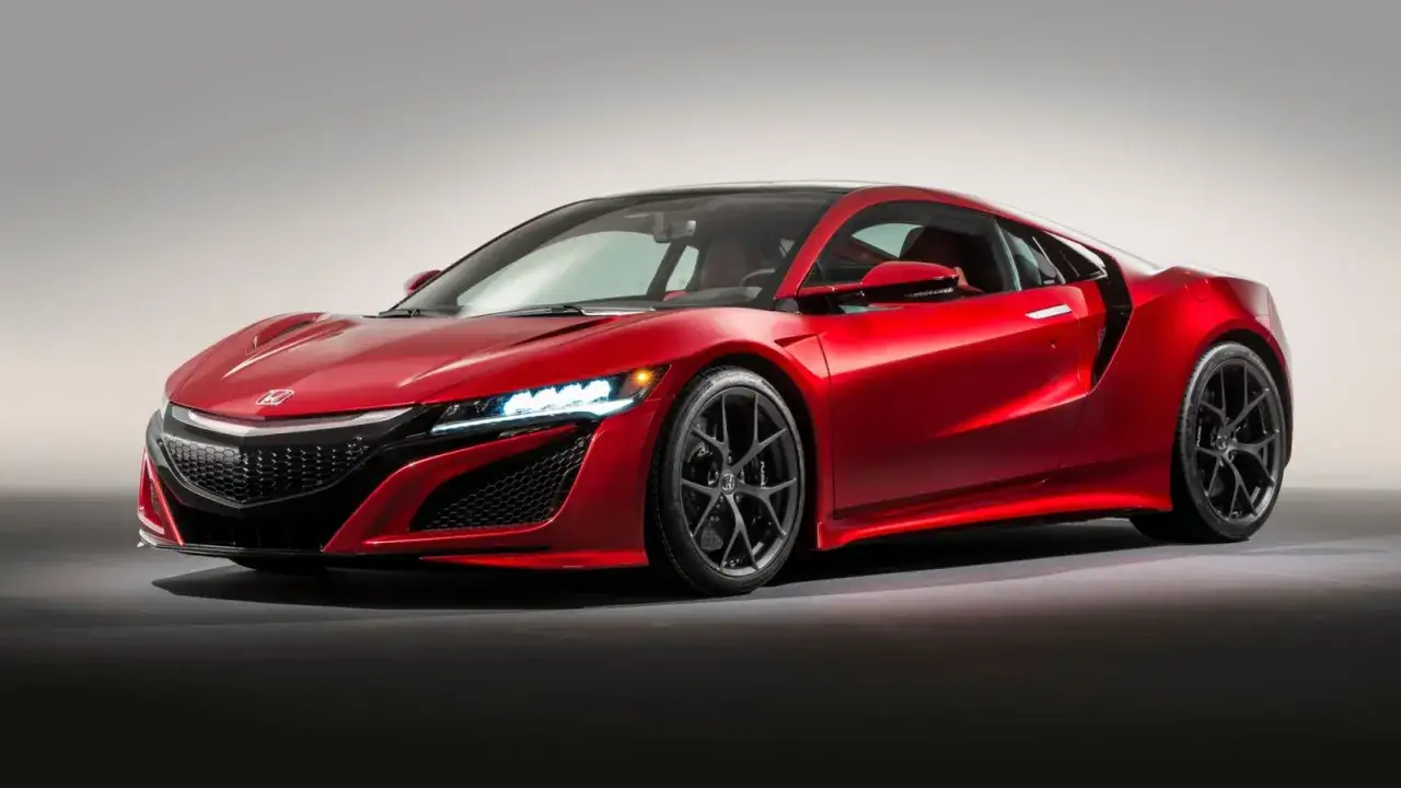 Czerwony Honda NSX z ostrymi liniami i agresywnym przodem, gotowy do podboju dr&oacute;g.