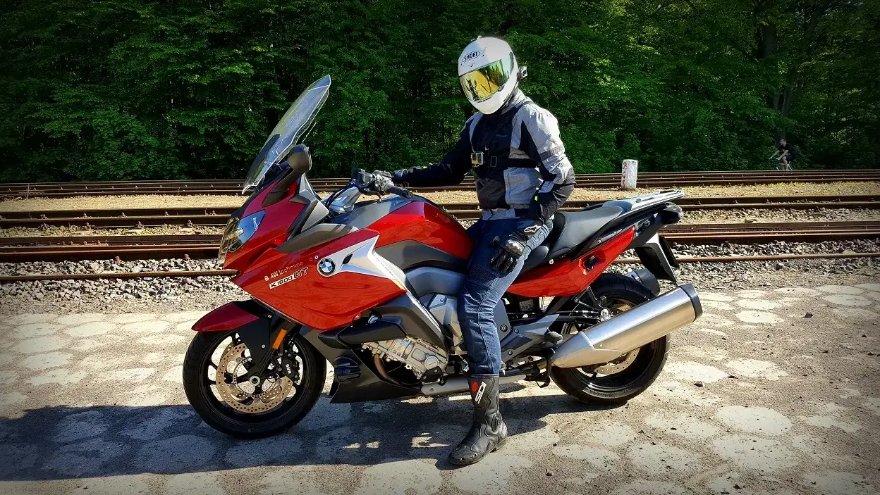 motocyklista w spodniach tekstylnych mesh na motocyklu turystycznym