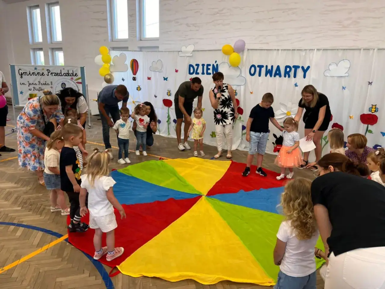 Kolorowy spadochron i dzieci na Dniu Otwartym w przedszkolu. Świetne pomysły na dni otwarte w przedszkolu!