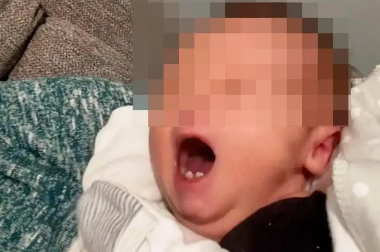 Małe ząbki u noworodka, kt&oacute;ry otwiera buzię.