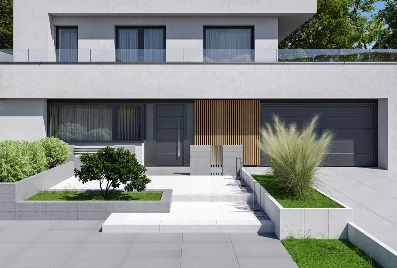 Nowoczesny dom z szarym podjazdem z kostki, ozdobiony zielenią i drewnianymi elementami.