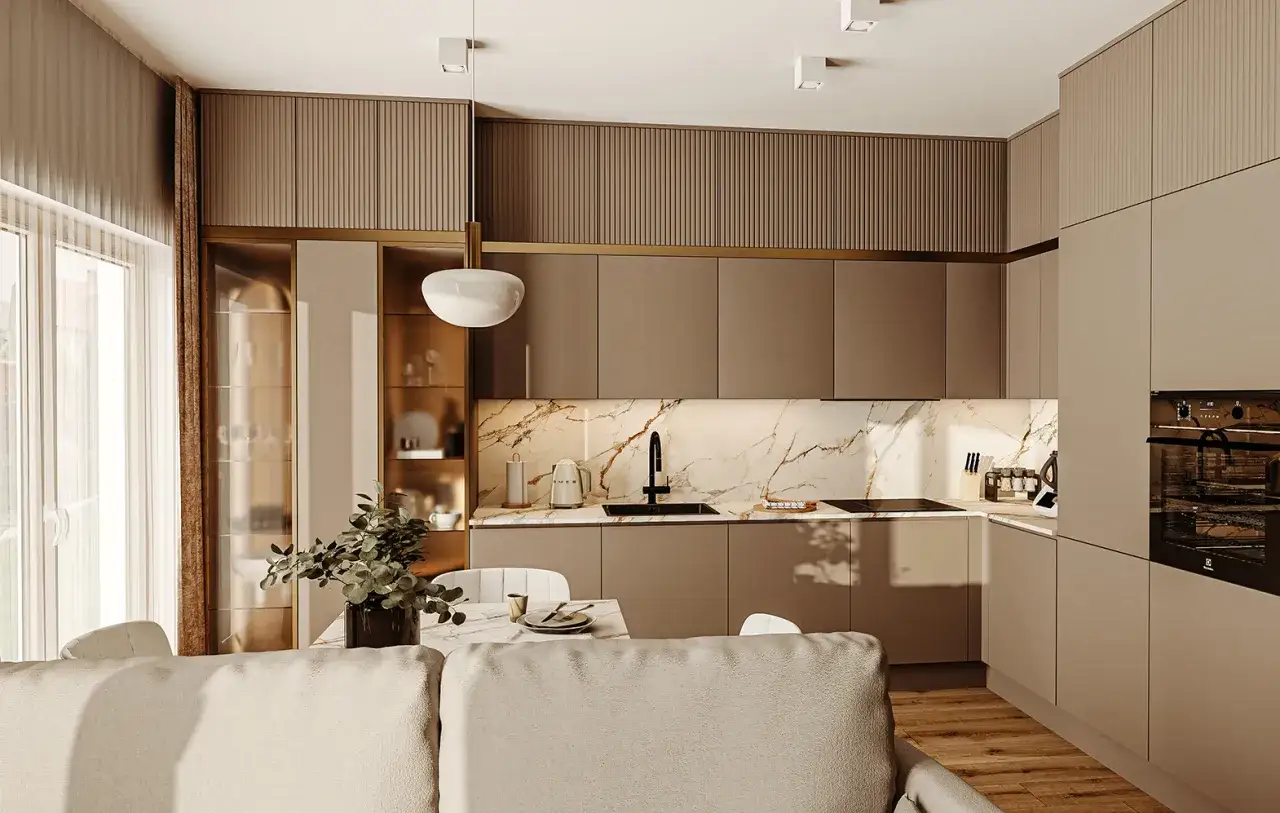 Nowoczesna kuchnia z marmurowym blatem i złotymi akcentami. Stół z krzesłami ustawiony prostopadle do okna, tworząc przytulną jadalnię.