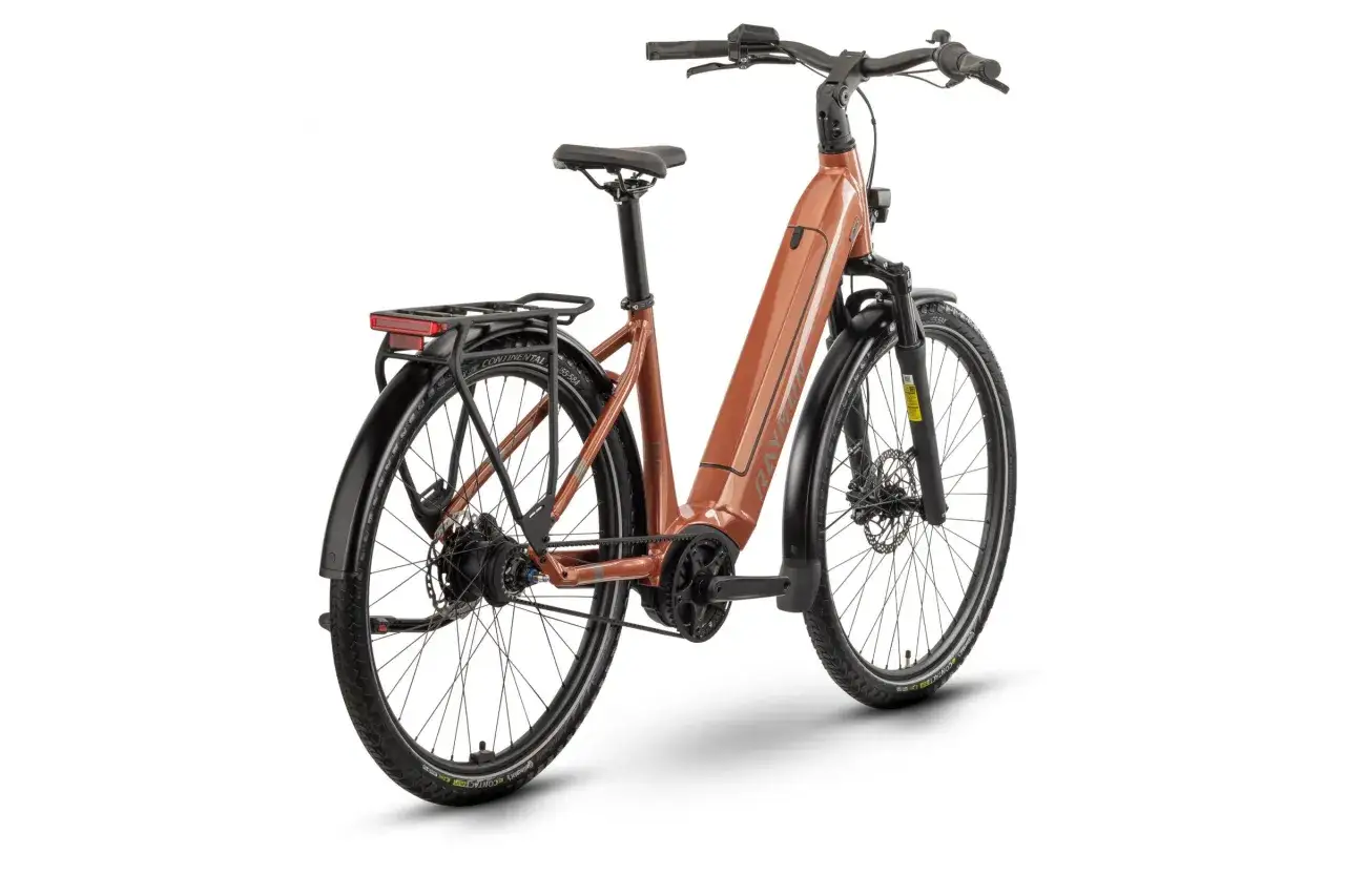 Brązowy rower elektryczny z bagażnikiem i błotnikami. Ten rower bez amortyzatora jest gotowy na miejskie przygody.