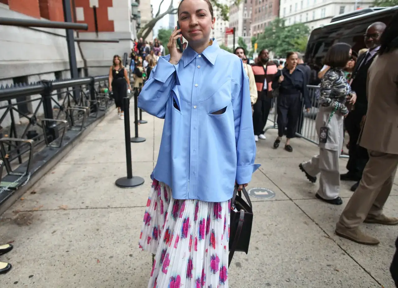 Koszula oversize damska stylizacje: błękitna, luźna koszula z wycięciami i plisowana sp&oacute;dnica w kwiaty.