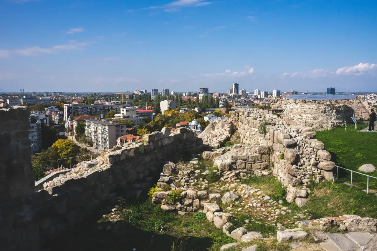 Ruiny twierdzy na wzgórzu w Plovdiv, Bułgaria, z widokiem na nowoczesne miasto.
