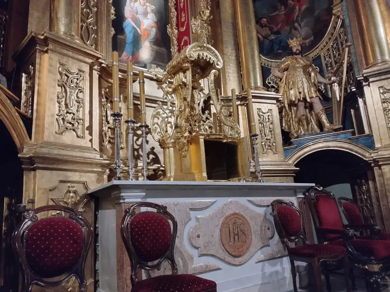 Złoty ołtarz i ozdobne krzesła w kościele, przygotowania do Wielkiego Piątku.