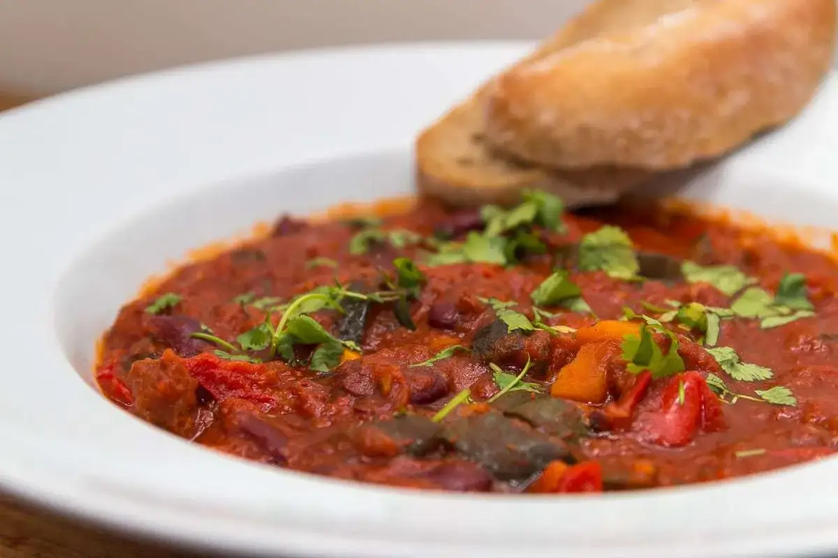 Gęste, aromatyczne leczo z warzywami i fasolą, posypane świeżą kolendrą, podane z chrupiącym pieczywem. Czy leczo jest zdrowe? Z pewnością tak, jeśli jest pełne warzyw!