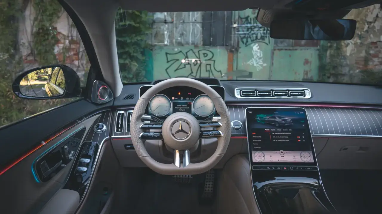 Wnętrze luksusowego Mercedesa S Klasa z nowoczesnym ekranem dotykowym i podświetleniem ambientowym.