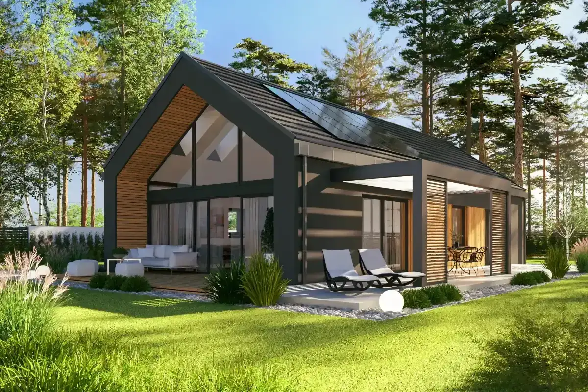 Tania nowoczesna stodoła z dużymi oknami i panelami słonecznymi, otoczona zielenią. Idealne miejsce na relaks.