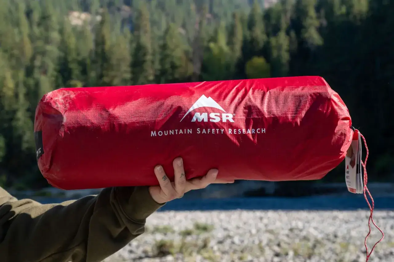 Czerwony pokrowiec z logo MSR, idealny na gadżety pod namiot. Gotowy na przygodę w g&oacute;rach.
