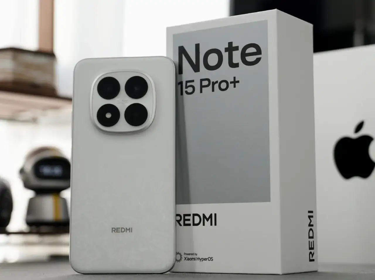 Biały, najnowszy Redmi Note 15 Pro+ z czterema obiektywami aparatu i pudełkiem.