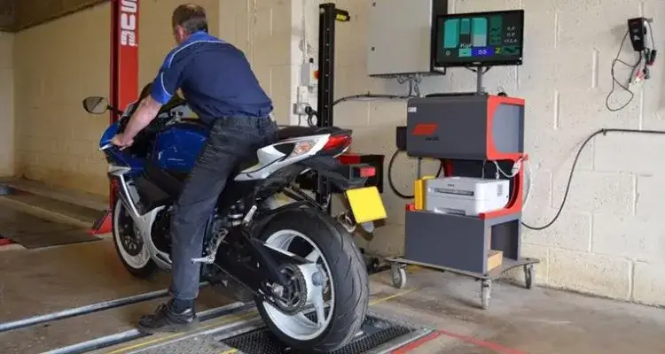 Diagnosta sprawdza motorower na stacji kontroli pojazd&oacute;w