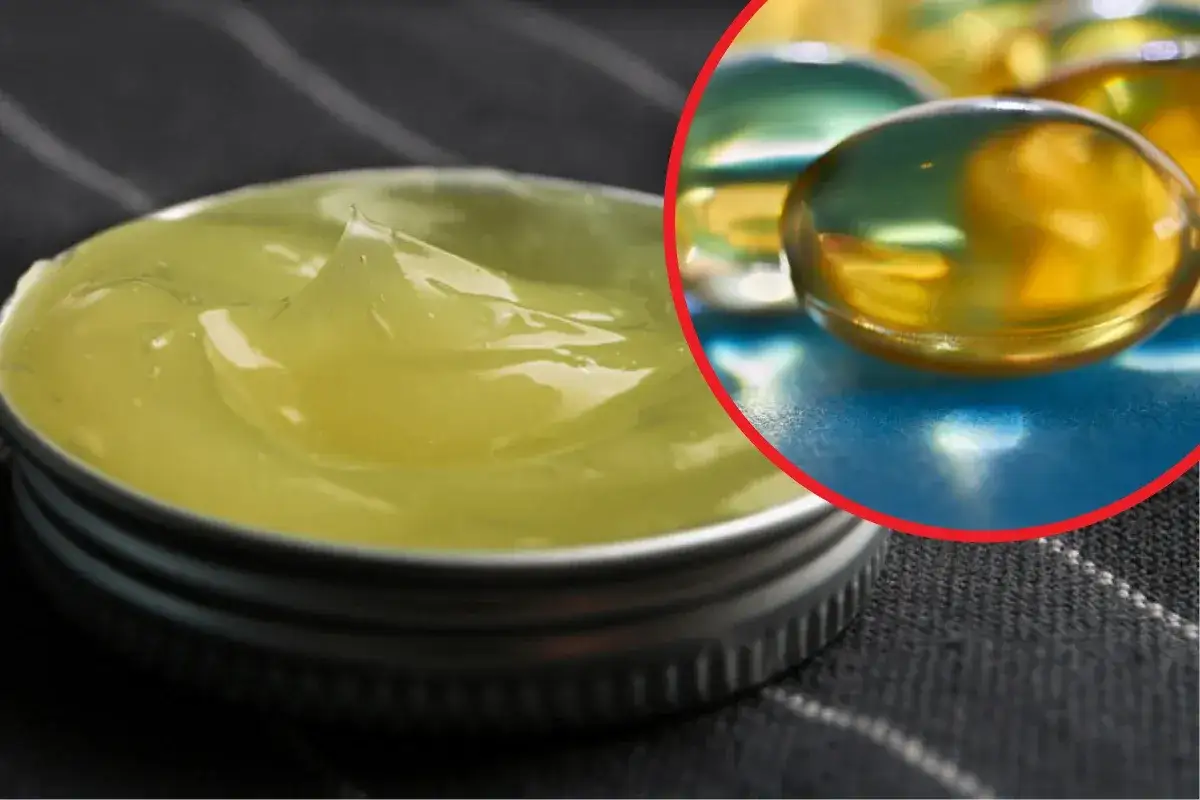 Gęsta, ż&oacute;łta maść tranowa na twarz w metalowym słoiczku, obok błyszczące kapsułki z olejem.