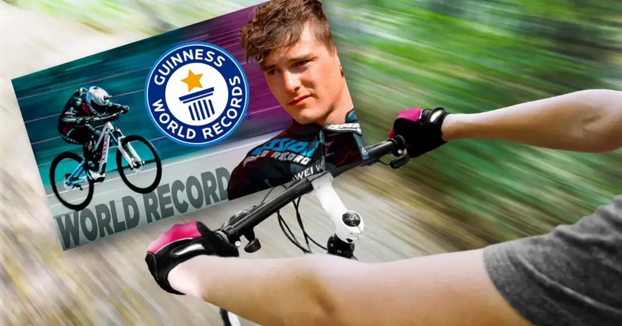 Kolarz w rękawiczkach ściga się na rowerze, celując w rekord prędkości na rowerze, z logo Guinness World Records.
