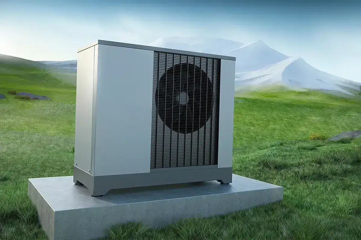 Nowoczesna pompa ciepła na tle zielonych wzgórz. Zastanawiasz się gwp co to? To wskaźnik wpływu na środowisko.