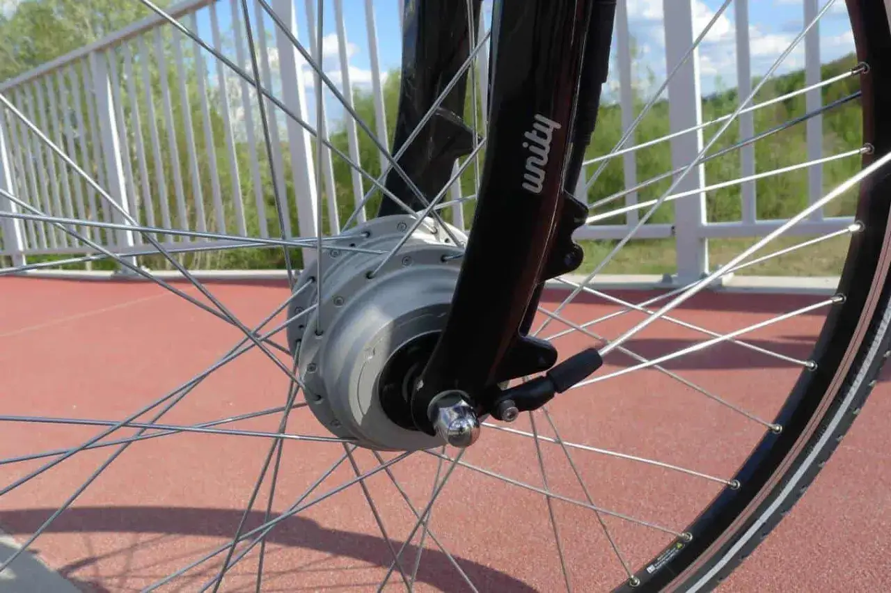 Szprychowe koło roweru elektrycznego z widocznym silnikiem w piaście. Czy na rower elektryczny trzeba mieć prawo jazdy? Sprawdź przepisy!