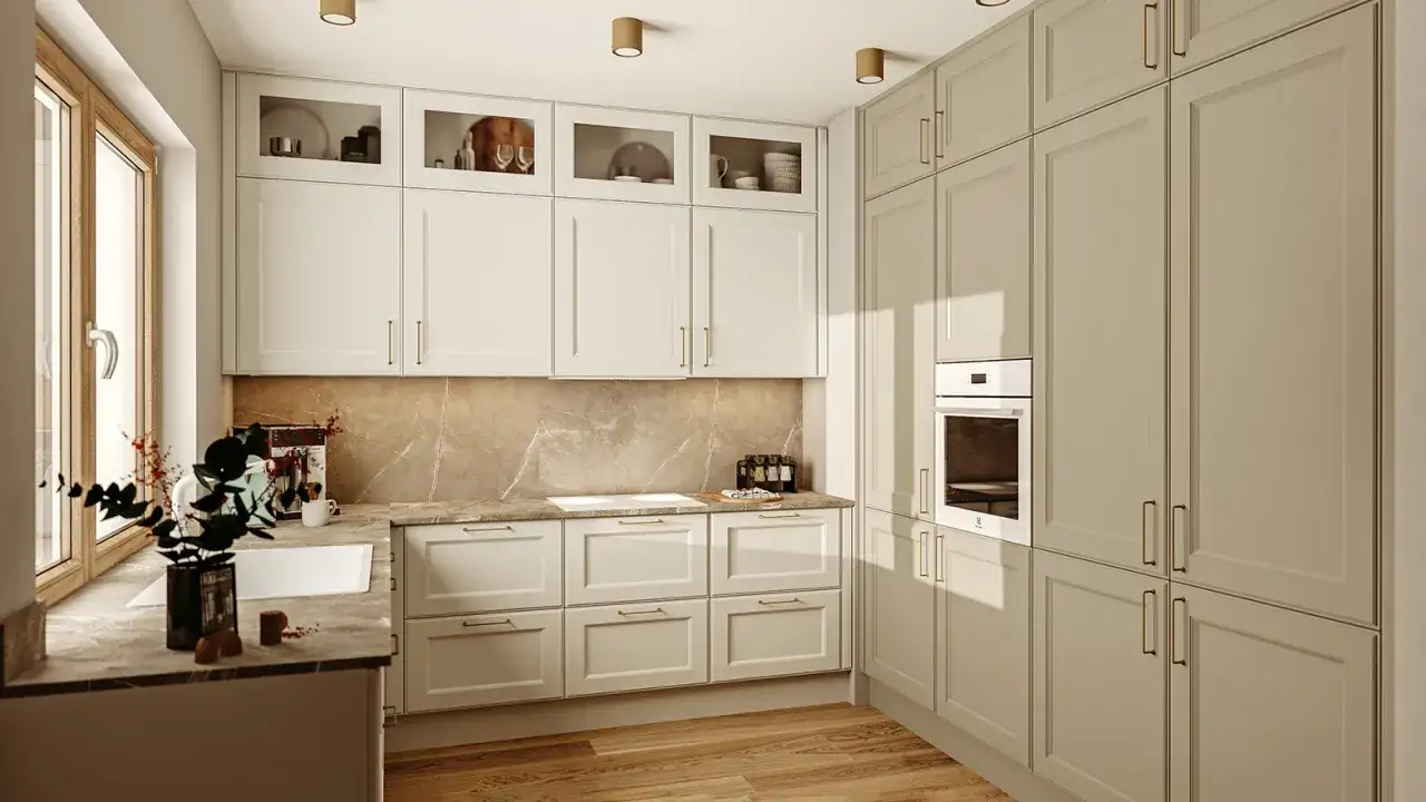 Nowoczesna kuchnia z jasnymi frontami, wbudowanym piekarnikiem i blatem imitującym marmur. Idealne miejsce, by dowiedzieć się, jak zabudować lodówkę.