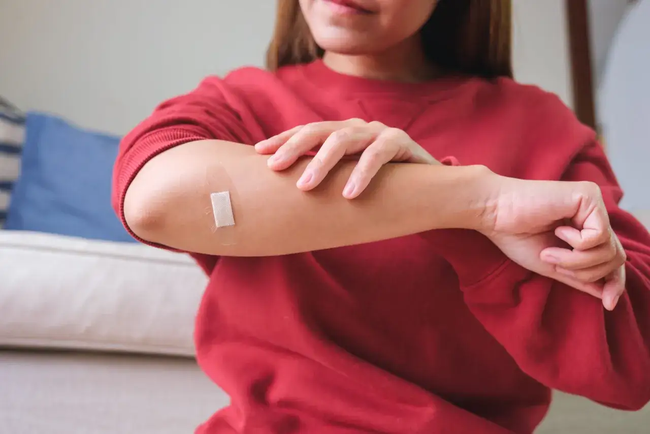 Kobieta z plastrem na ramieniu.