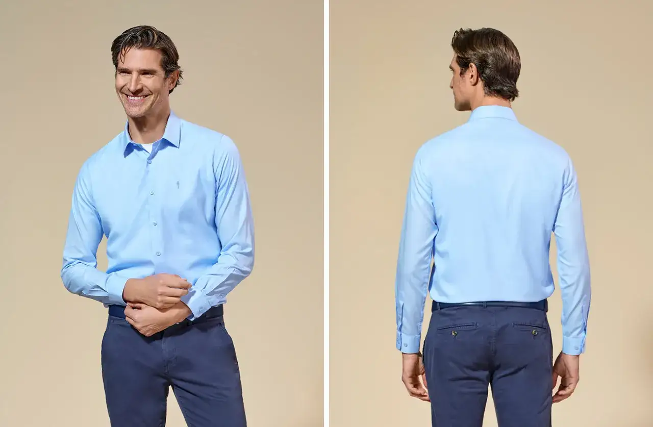 Mężczyzna w błękitnej koszuli i granatowych spodniach. Czy koszula powinna być w spodniach? Tutaj widać obie opcje.