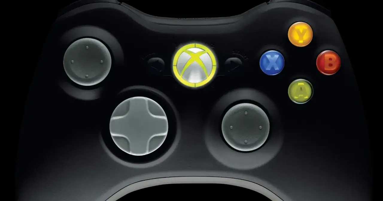 Zbliżenie na czarny kontroler Xbox 360 z podświetlonym logo Xbox i kolorowymi przyciskami.