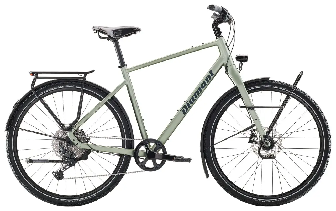 Zielony rower miejski firmy Diamant z bagażnikiem i błotnikami, gotowy na miejskie przygody.